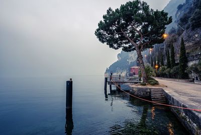 Scenic view of lake garda in mist