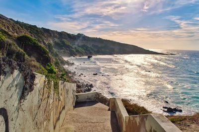 Scenic view of beach against sky during sunset