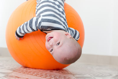 Portrait of cute baby boy lying on bed at home