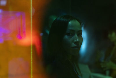 Portrait of serious businesswoman in illuminated convention center