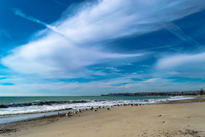 Scenic view of beach against blue sky