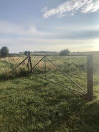 Fence on field against sky