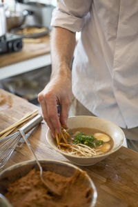 Midsection of man preparing food