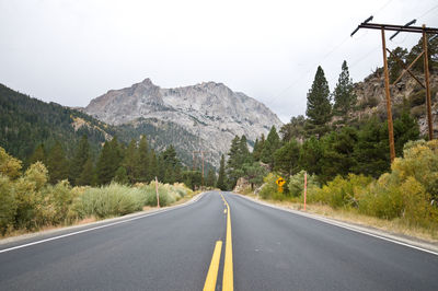 Road amidst mountains against clear sky