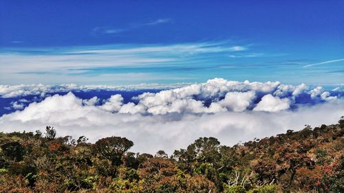 Scenic view of mountains against blue sky