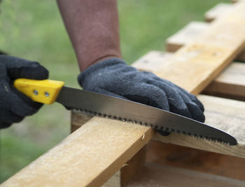 Close-up of man working on wood