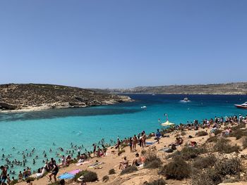 Crowd at beach on sunny day