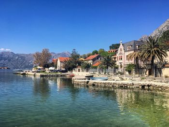 Scenic view of lake against clear blue sky