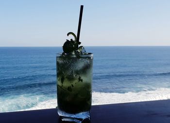 View of drink on table against sea