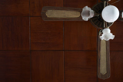 Directly below shot of chandelier ceiling fan in modern building
