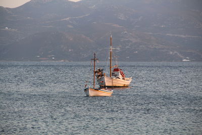 Boat sailing in sea against sky