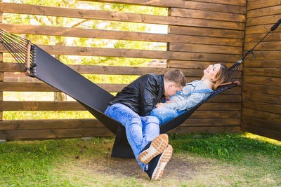 Low section of friends sitting on floor