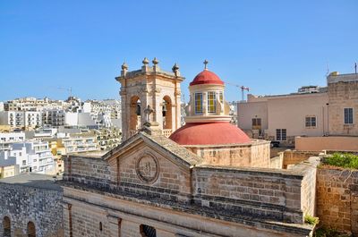 Buildings against clear blue sky