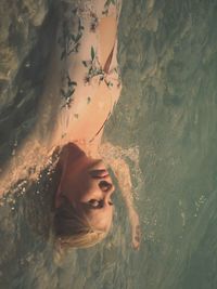 Portrait of a young woman in swimming pool