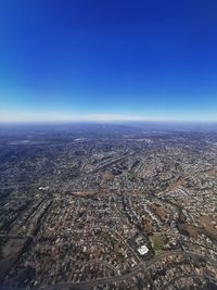 High angle view of city against clear blue sky