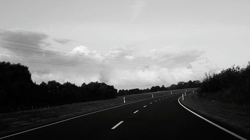 Empty country road along trees