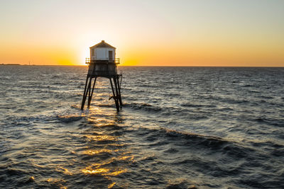 Scenic view of sea against clear sky during sunset