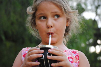 Portrait of woman drinking water