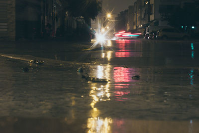 Illuminated city street at night