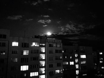 Illuminated city against sky at night