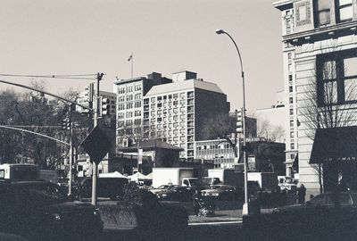 Street lights in city against sky