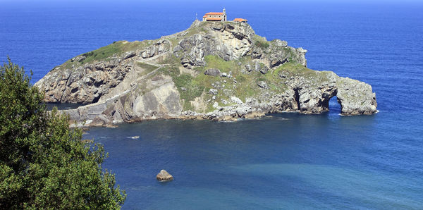 High angle view of rocks by sea against sky