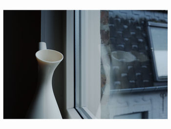 Close-up of coffee cup on window