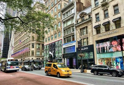 Cars on street amidst buildings in city