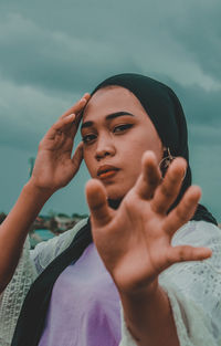 Portrait of a beautiful young woman holding hands