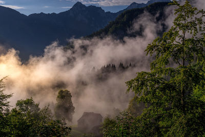 Scenic view of mountains against sky in misty morning