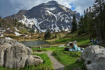 Woman laying down in nature in austrian alps