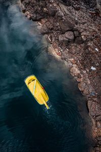 High angle view of yellow leaf floating on water