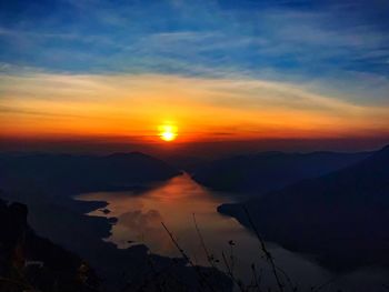 Scenic view of silhouette mountains against sky during sunset