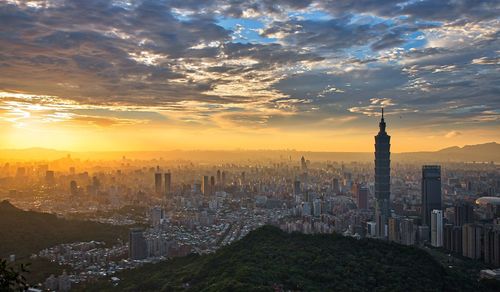 Aerial view of city buildings during sunset