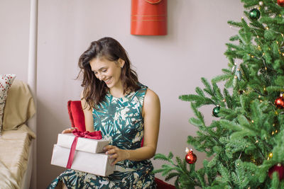 Young woman looking at christmas tree