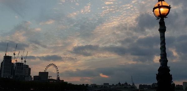 Low angle view of buildings against cloudy sky