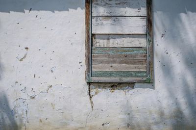 Close-up of weathered window on wall