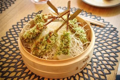 High angle view of food in container on wooden table