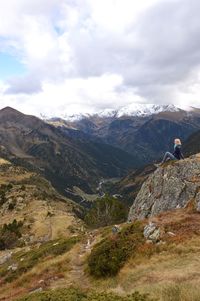 Girl is sitting on the top of the peak