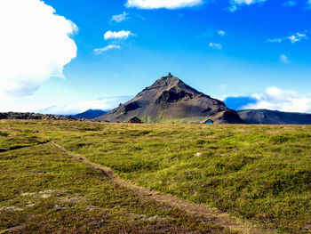 Built structure on field against sky