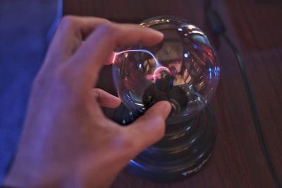 Close-up of hand holding glass of table