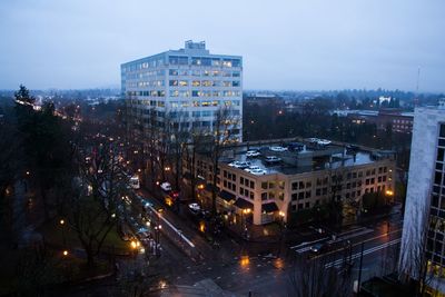 High angle view of road by buildings in city at dusk