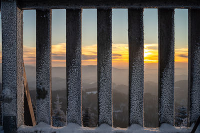 Panoramic shot of icicles on beach against sky during sunset