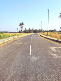 Road amidst plants against sky