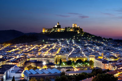 High angle view of illuminated buildings in town at night