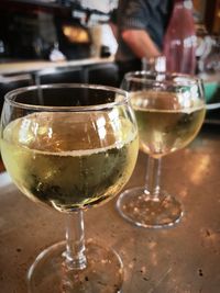 Close-up of wine glasses on table in cafe