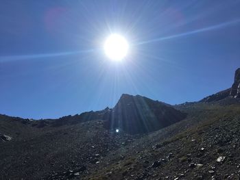 Sun shining over mountain range