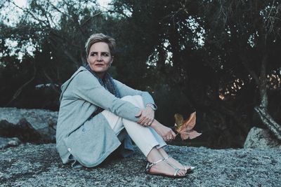 Portrait of smiling woman sitting outdoors