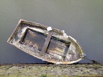 Directly above shot of damaged boat moored on river