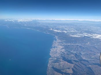 Aerial view of snowcapped mountains against sky